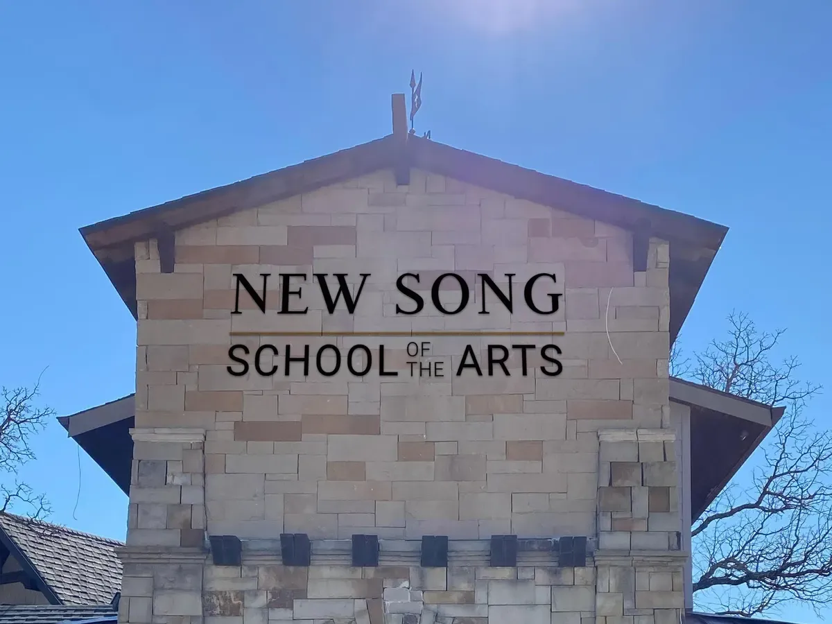 The New Song School of the Arts building in Argyle, Texas, under a clear sky